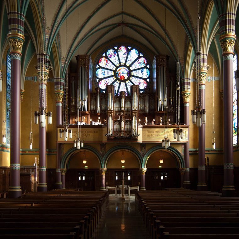 Church interior with rose window and organ
