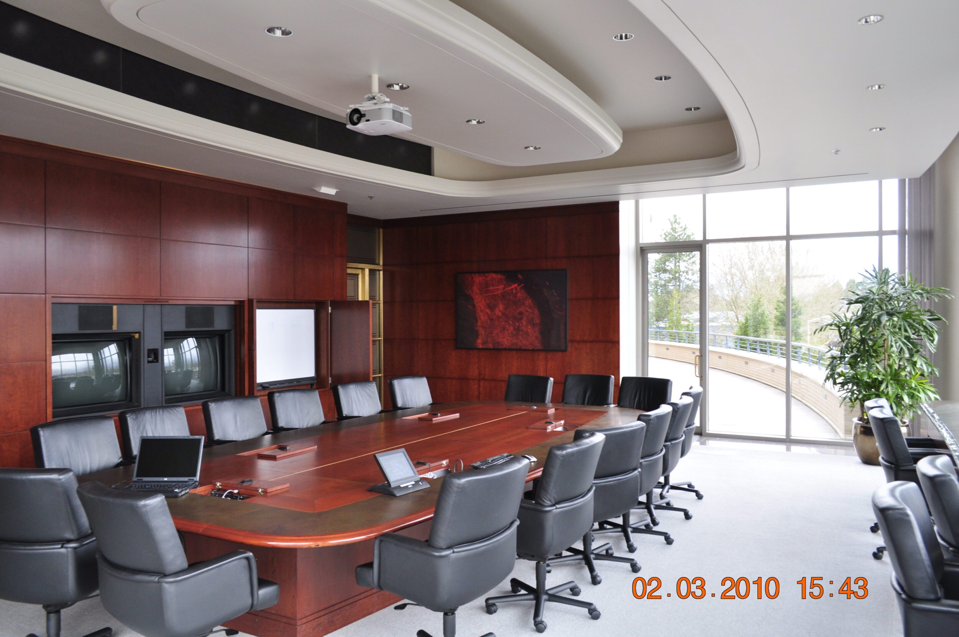 Modern boardroom with long wooden conference table